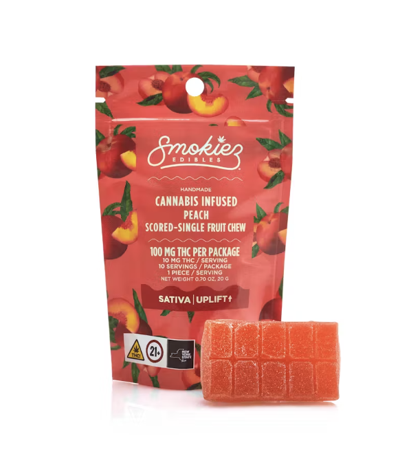 Handmade cannabis-infused peach fruit chew from Smokiez Edibles, featuring vibrant packaging with peach illustrations, highlighting 100 mg THC per package and sativa uplifting effects.